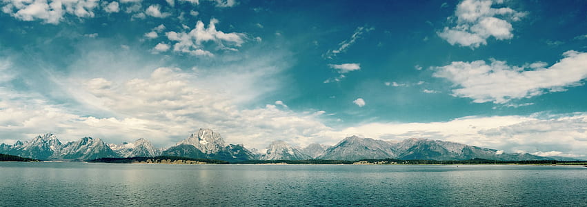 blue mountain near body of water thumbnail