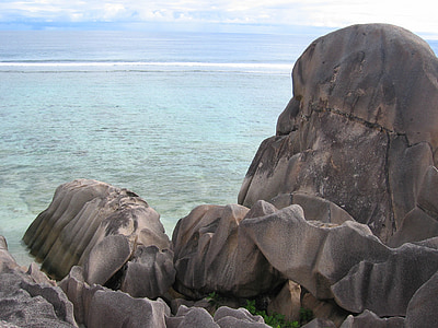 rock formation near body of water at daytime thumbnail