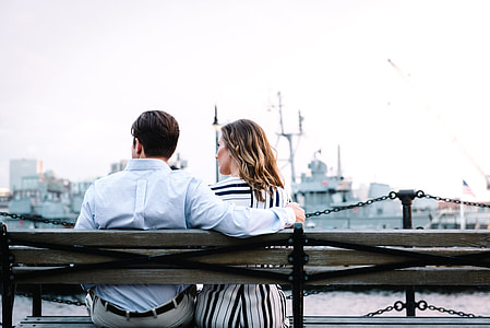 man and woman sitting on bench thumbnail
