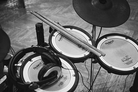 grayscale photo of drum stick and headphones on drum pad thumbnail