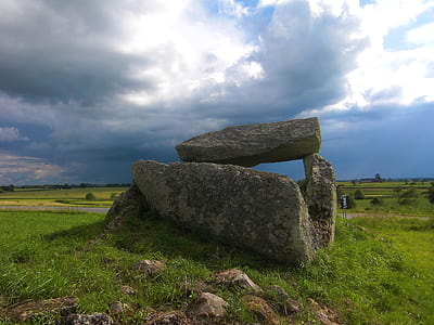 rock formation under nimbus clouds thumbnail