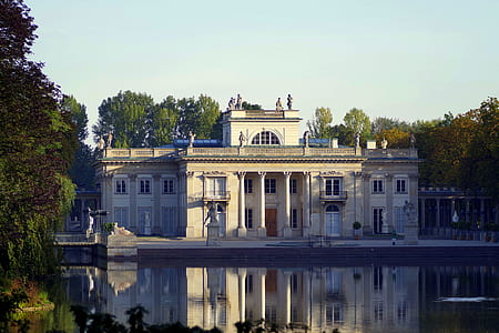 gray mansion in front of lake thumbnail