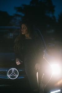 woman leaning on black Mercedes-Benz vehicle at daytime thumbnail