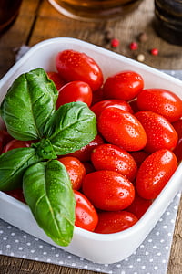 red fruits in bowl with green leaves thumbnail