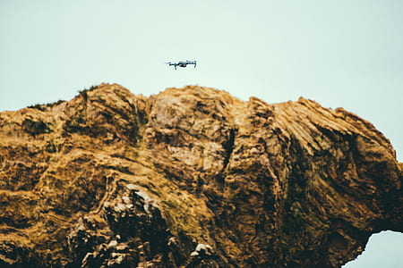 white drone flying around boulder thumbnail