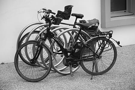 Black and Grey Bicycle Park Beside Wall thumbnail