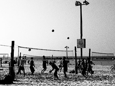 grayscale photography of people playing volleyball thumbnail