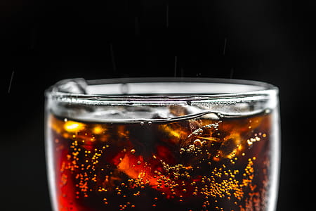 Clear Drinking Glass Filled With Brown Liquid and Ice thumbnail