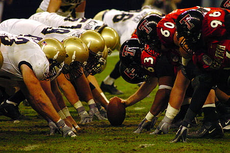 football players on green grass field thumbnail