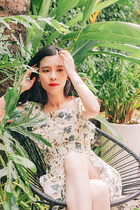 Woman Sitting in Chair Beside Plant thumbnail
