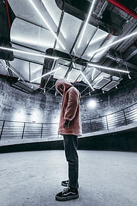 man standing under well lighted ceiling thumbnail