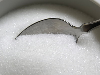 gray stainless steel spoon on white sugar powder thumbnail