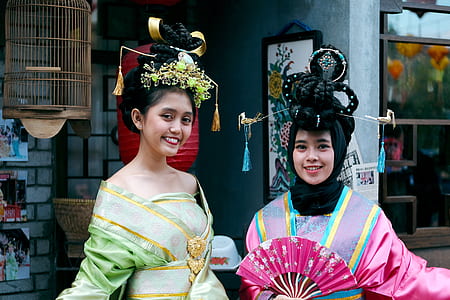 two women standing on front of red paper lantern thumbnail