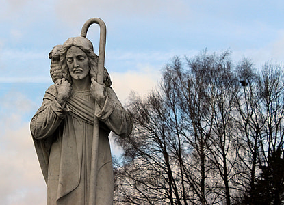 man carrying basket and cane concrete statue at daytime thumbnail