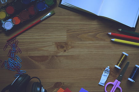 purple scissors on brown wooden surface thumbnail