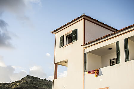 White Concrete House Under Blue Sky thumbnail