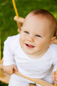 toddler in white long-sleeved shirt thumbnail