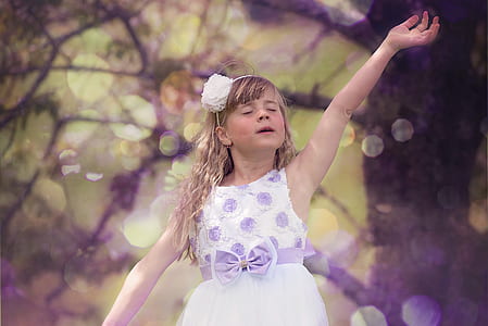 girl wearing white and purple floral sleeveless dress near trees thumbnail