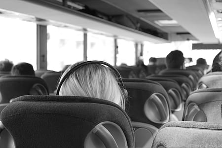 grayscale photo of person wearing headphones in bus thumbnail