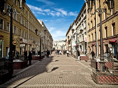 people standing in between buildings thumbnail