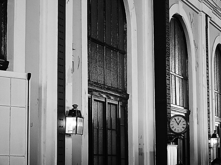 gray scale photography of black lantern on white wall