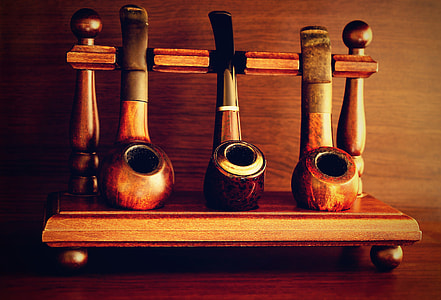 three brown smoke pipes on top of table thumbnail