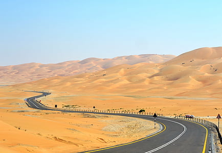 empty curved road in the middle of desert thumbnail