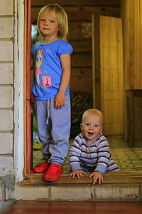boy and girl standing beside door thumbnail