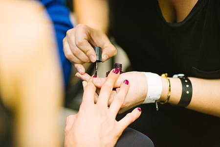 woman manicuring another woman's fingernails thumbnail