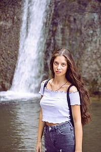 woman standing near waterfall thumbnail