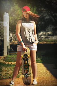 woman in gray tank top holding skateboard thumbnail