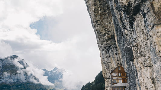 brown house near the cliff at daytime thumbnail