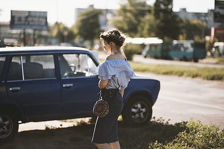 Woman Walking Near Sedan thumbnail