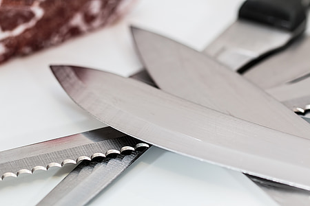 selective focus photography of kitchen knives on white surface thumbnail