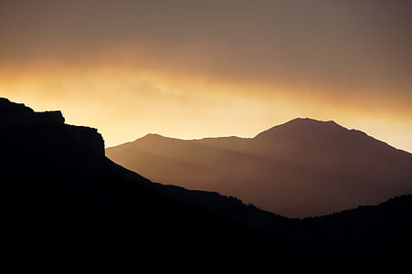 silhouette of mountains under orange sky thumbnail
