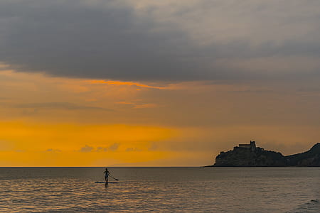 body of water under gray sky thumbnail