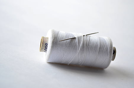 white thread on white surface thumbnail