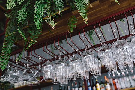 A big bunch of wine glasses hanging from a holder thumbnail