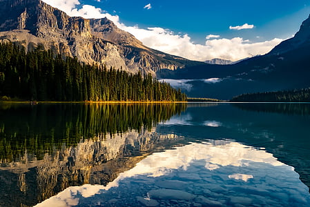 landscape photo of body of water within mountain range thumbnail