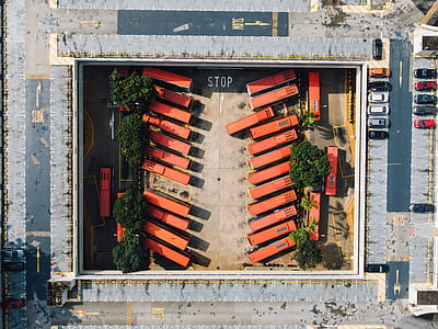 aerial view of orange buses during daytime thumbnail