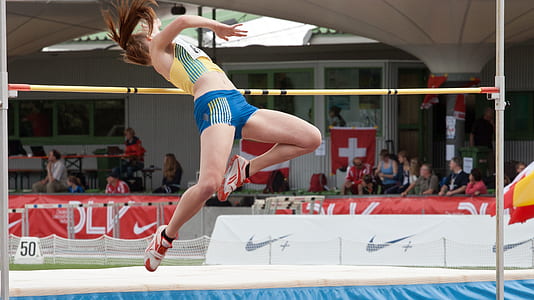 woman jumping over pole thumbnail