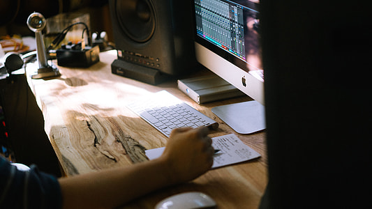 person sitting near beige wood stamp desk thumbnail