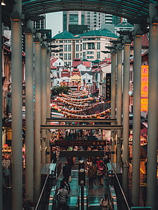 people gathering in between buildings at daytime thumbnail