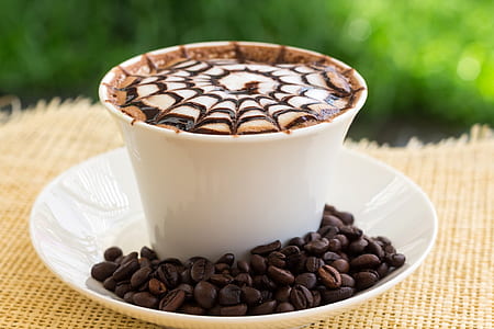 coffee beans beside ceramic cup during daytime thumbnail