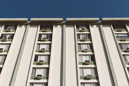 white painted apartment under clear blue sky during daytime thumbnail