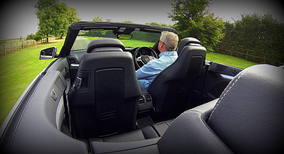 man riding convertible car during daytime thumbnail