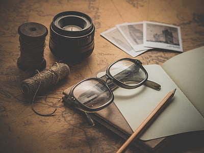 black framed wayfarer eyeglasses beside black camera lens thumbnail