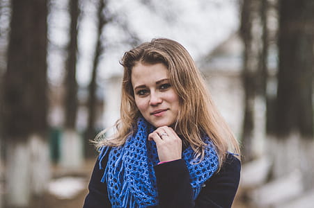 Selective Focal Photo of Woman Wearing Blue Knitted Mesh Infinity Scarf thumbnail