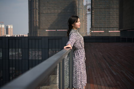woman standing on building roof top thumbnail
