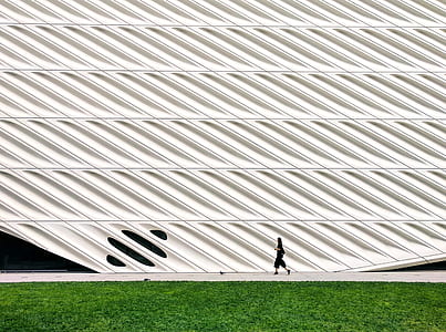 man walking near grass field thumbnail